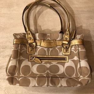 Beige and white Coach purse with gold detail